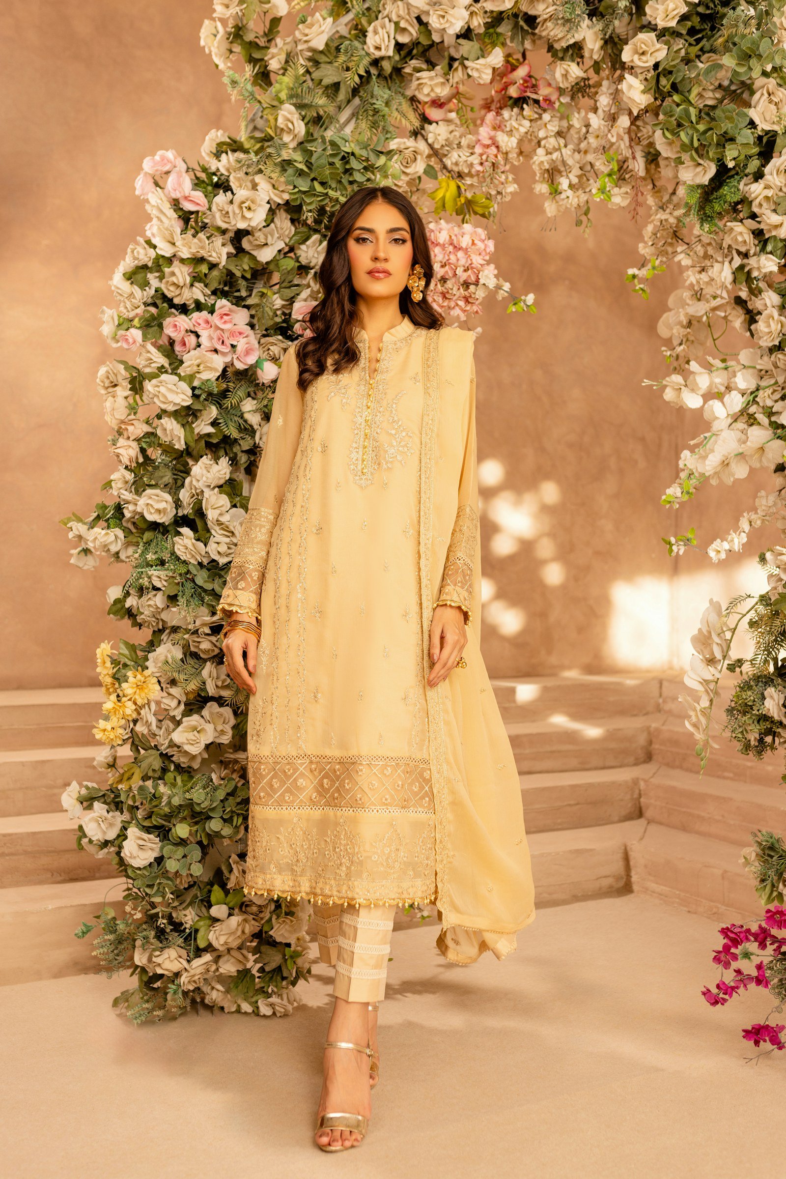 Woman wearing an elegant cream embroidered suit