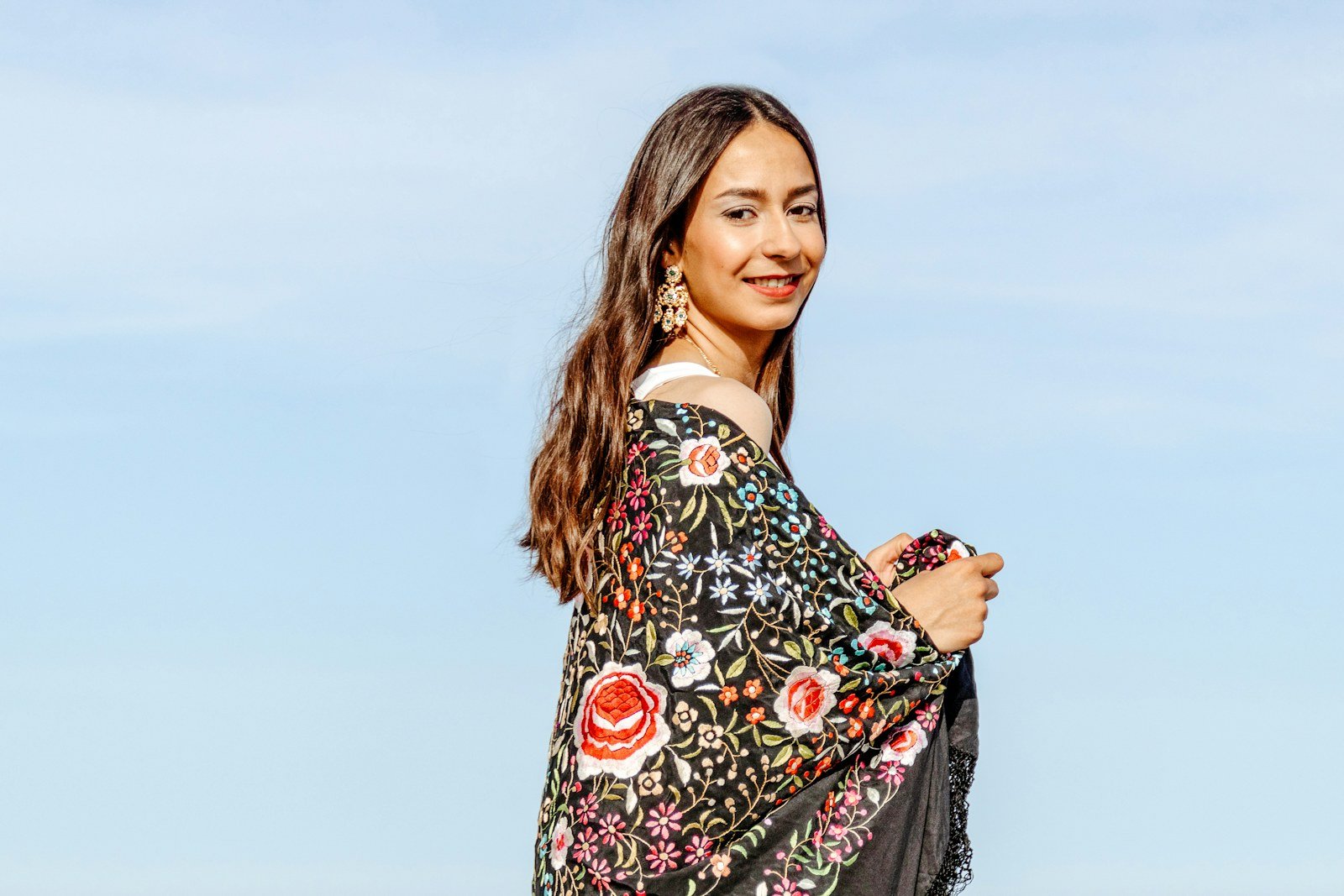 Smiling woman wrapped in a floral shawl