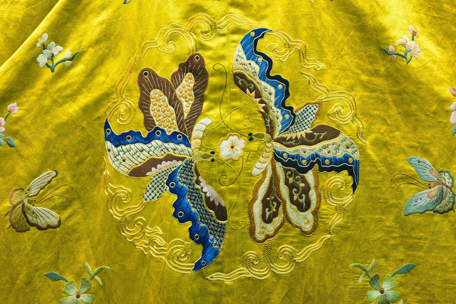Close-up of colourful embroidery on silk