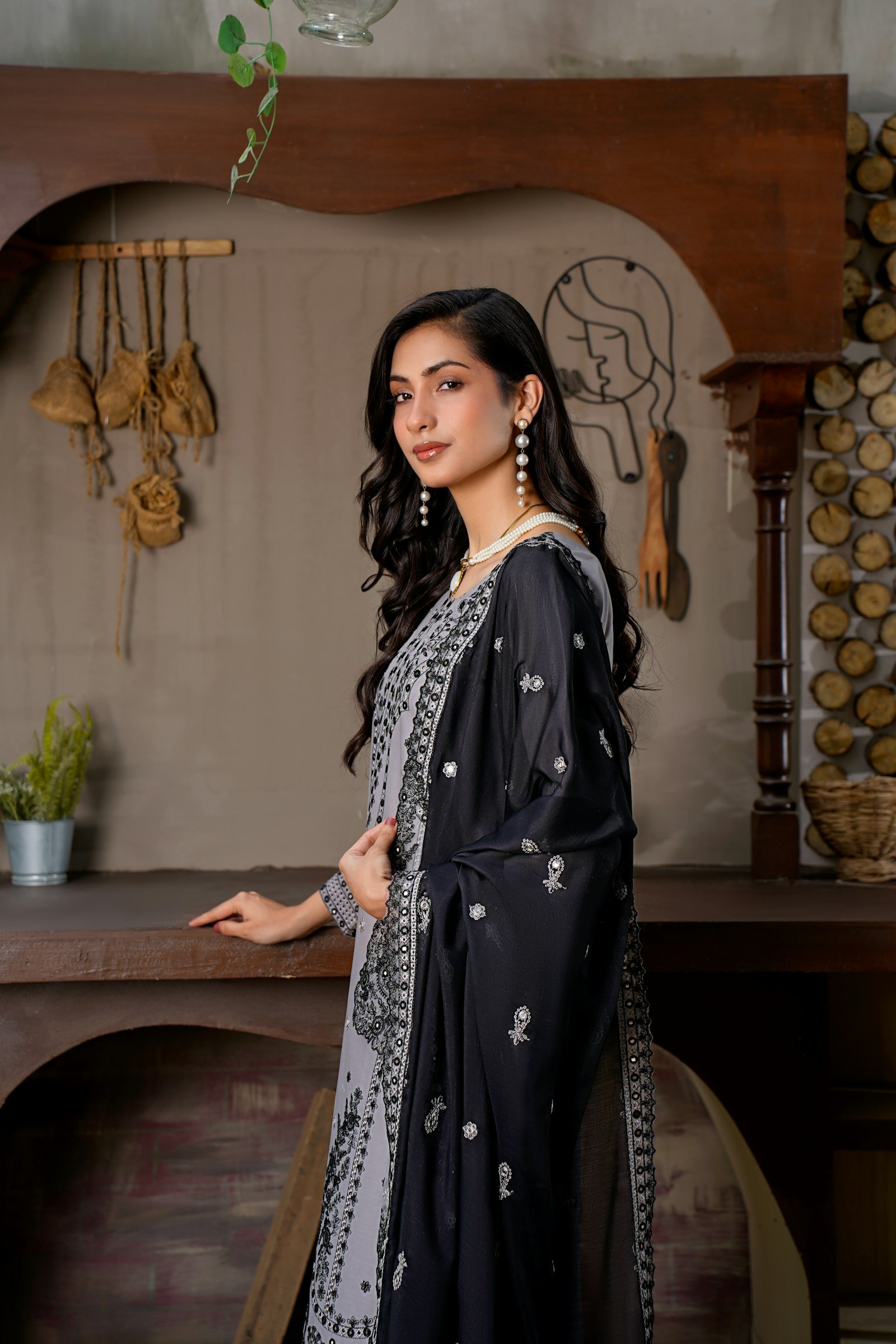 Woman in a black embroidered formal suit