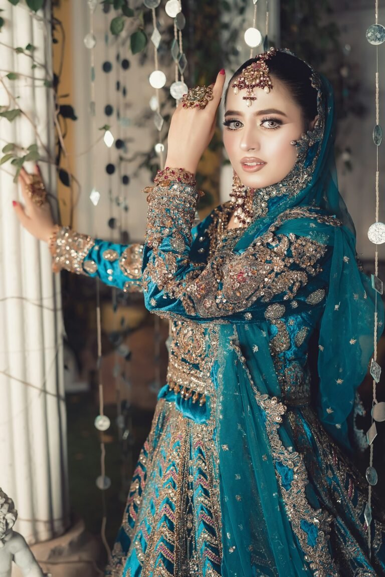 Woman in a teal embellished formal outfit