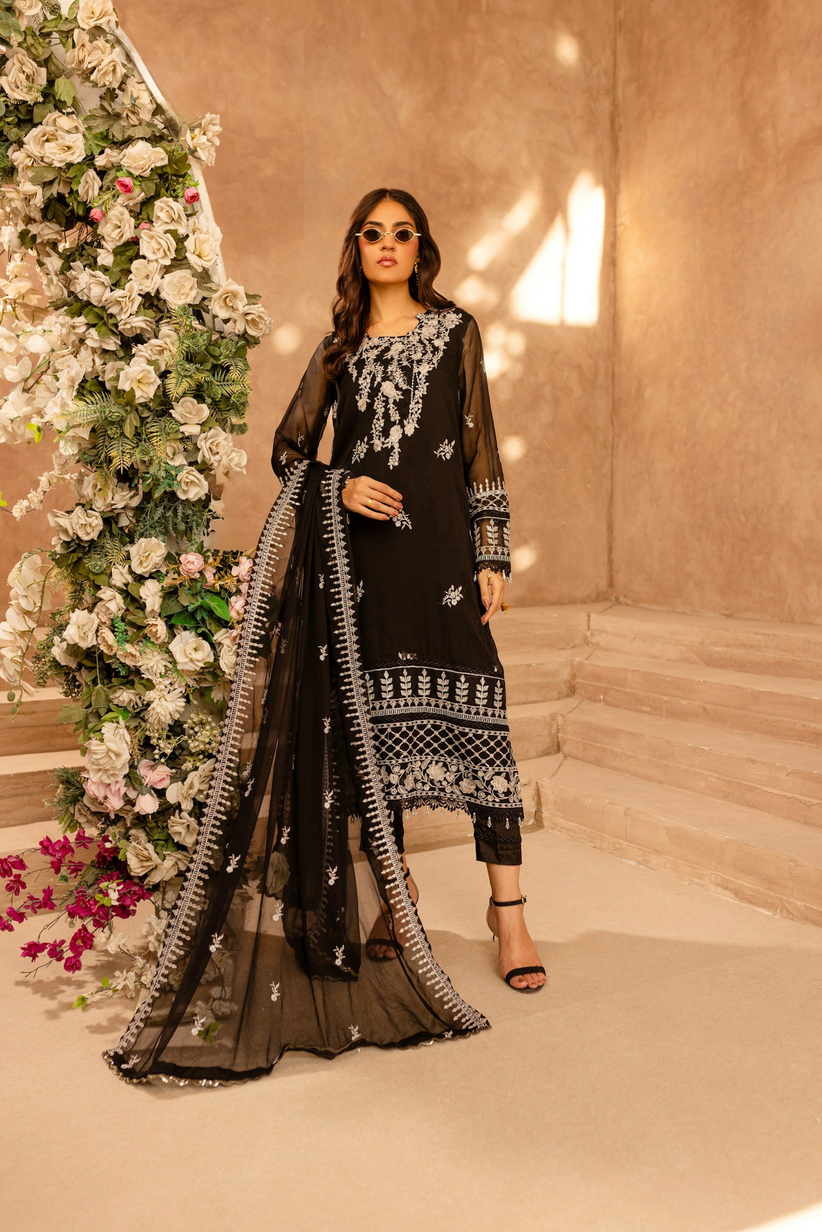 Model in a black embroidered three-piece suit