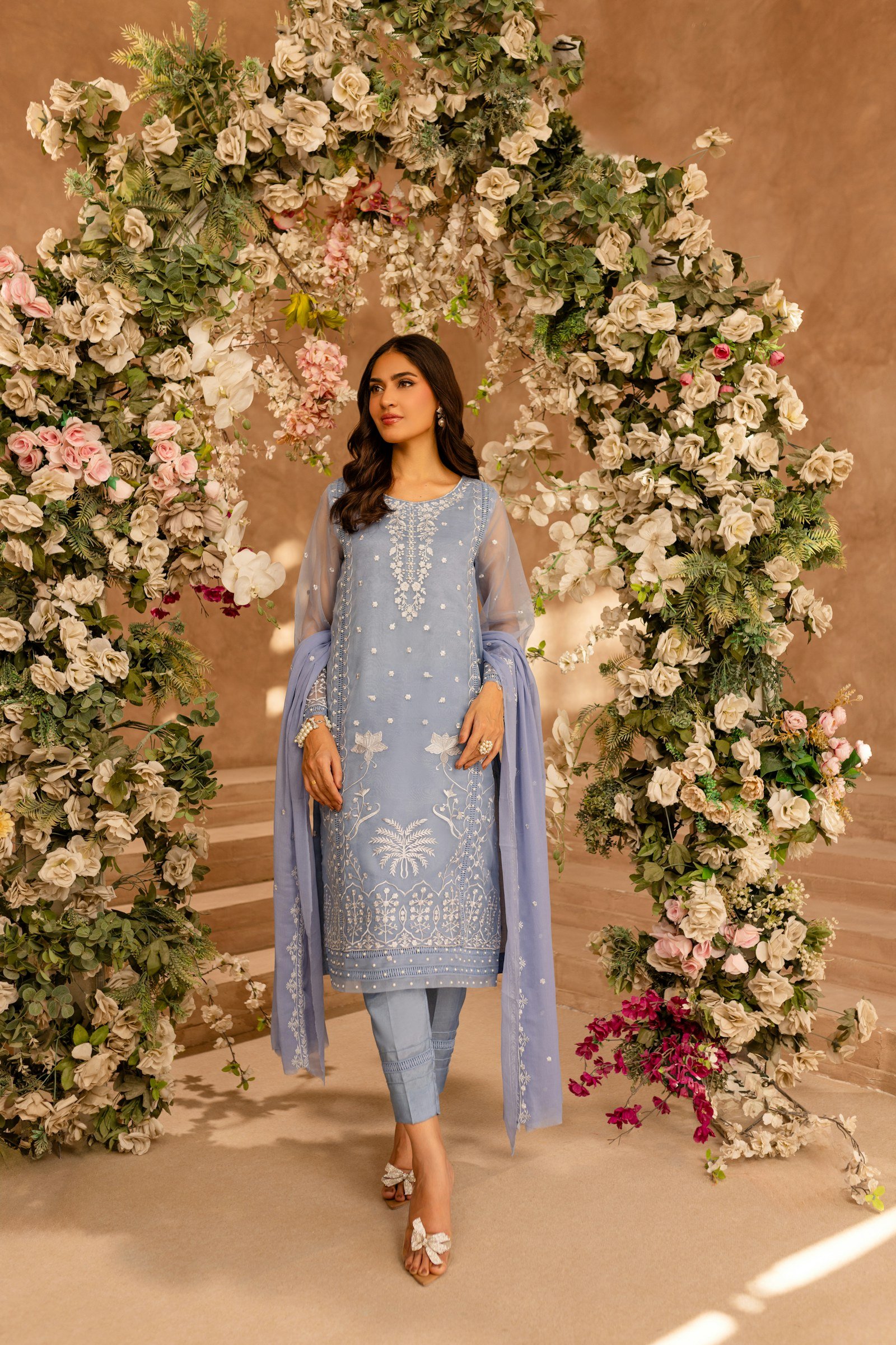 Model in a powder blue embroidered suit