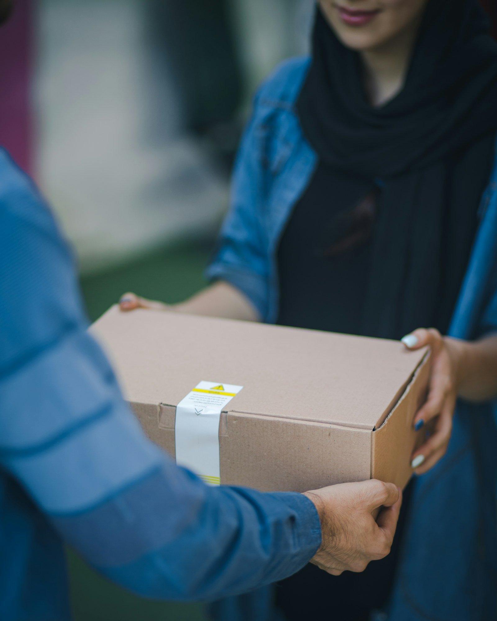 Hands holding a delivery parcel