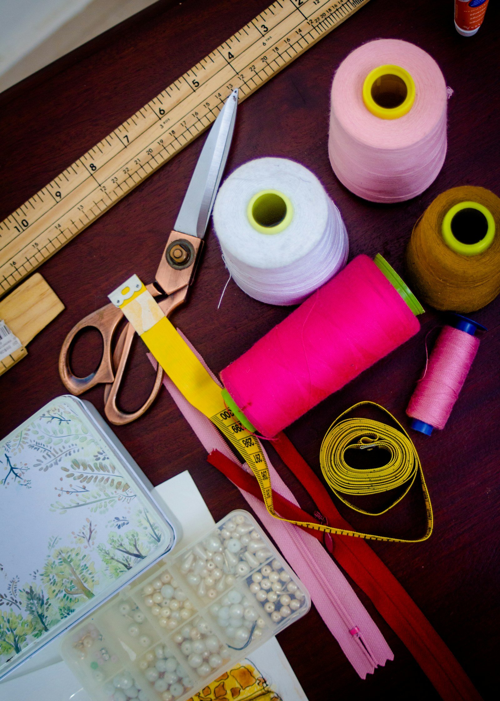 Threads, scissors and fabric on a tailoring table